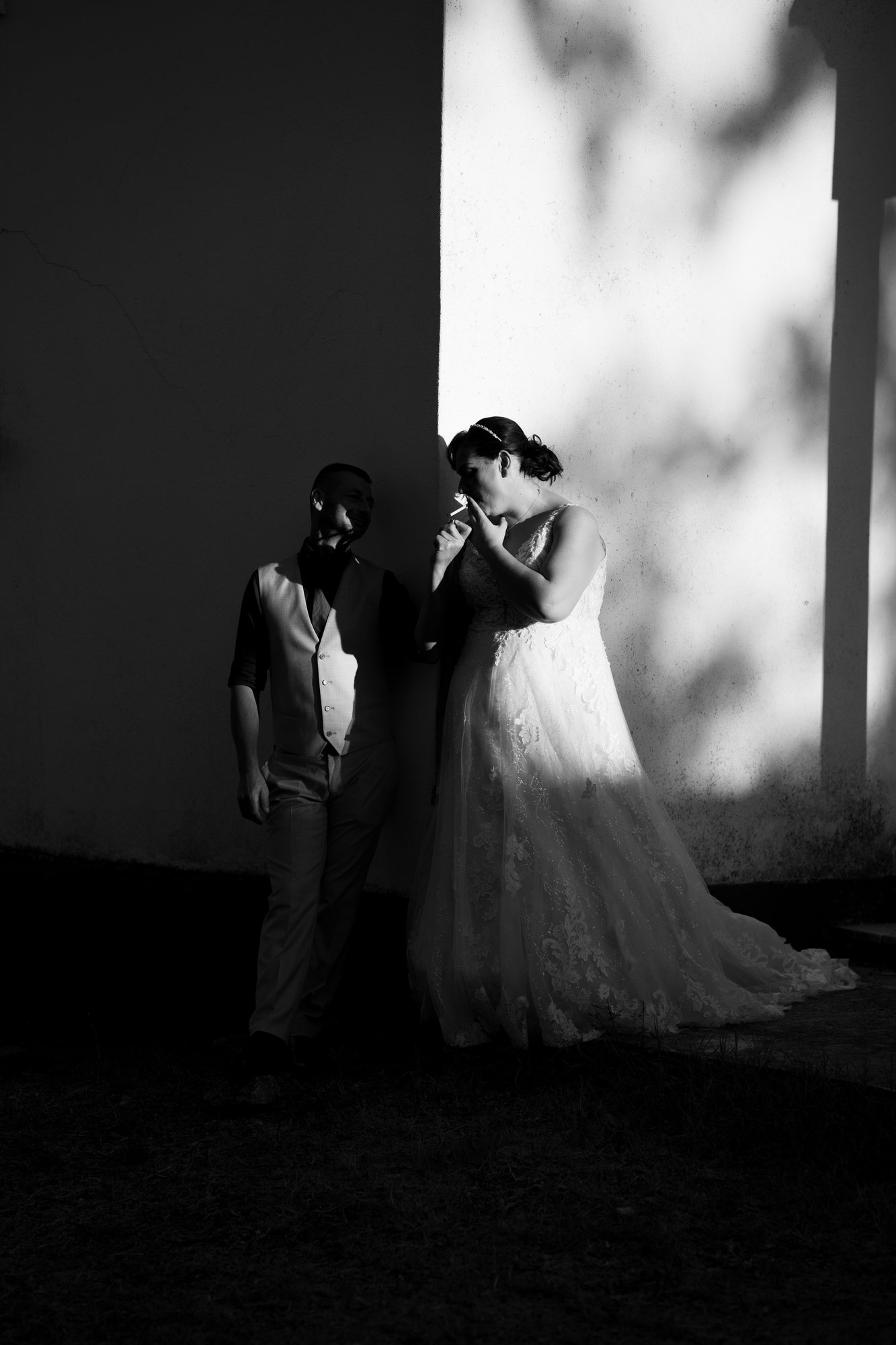 Black and white photo of the couple standing in a shaft of light